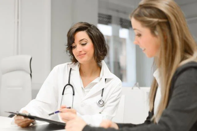 Nurse conferring with smiling patient