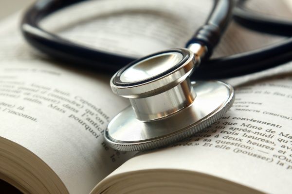 Close-up of a stethoscope on top of an open book