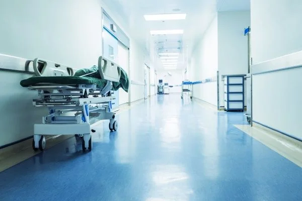 A brightly lit empty hospital corridor