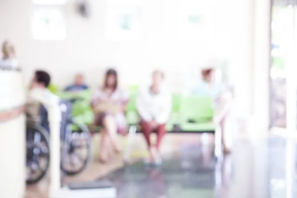 A group of patients in a hospital waiting room with whitewashed effect