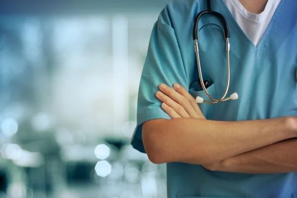 Close-up of male nurse with arms crossed