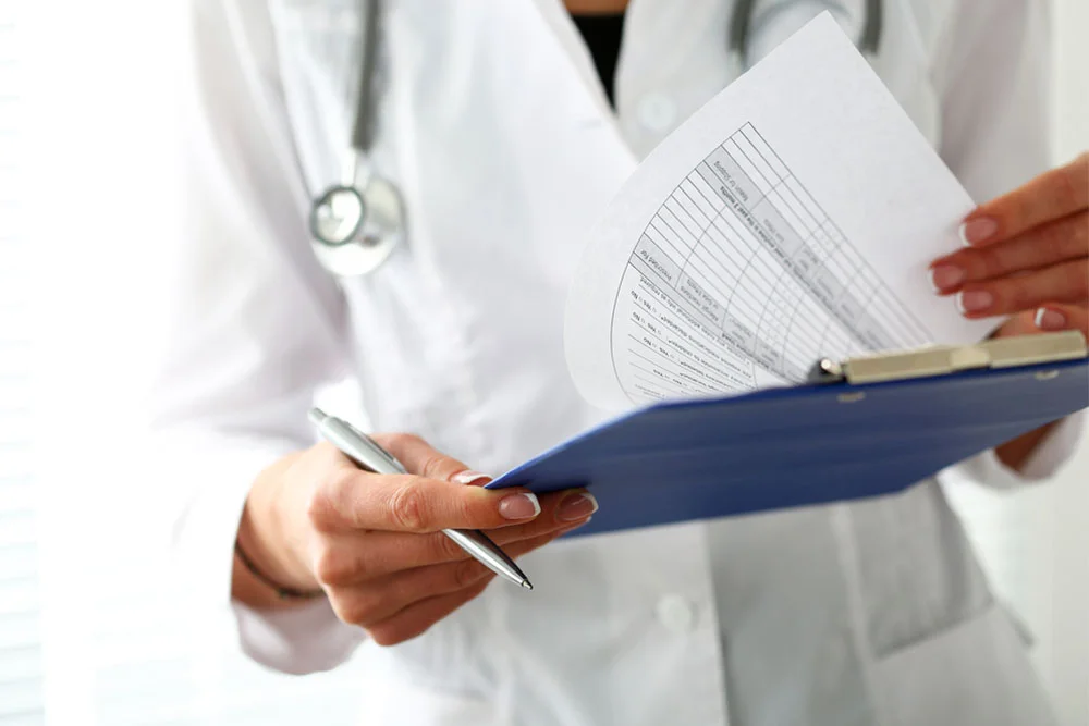 Female Nurse Practitioner helping patients on computer