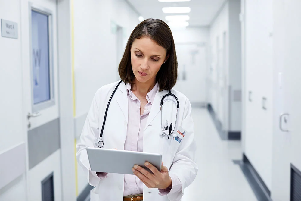 Female Nurse Practitioner working on tablet