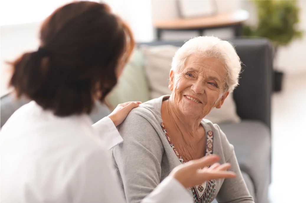 High salary earning nurse practitioner comforting an elderly female patient