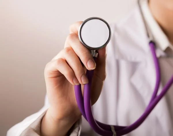 Close-up of a doctor holding up a stethoscope