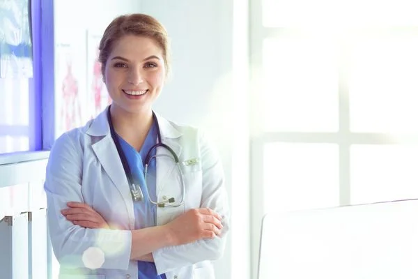 Smiling female nurse practitioner in a brightly lit office