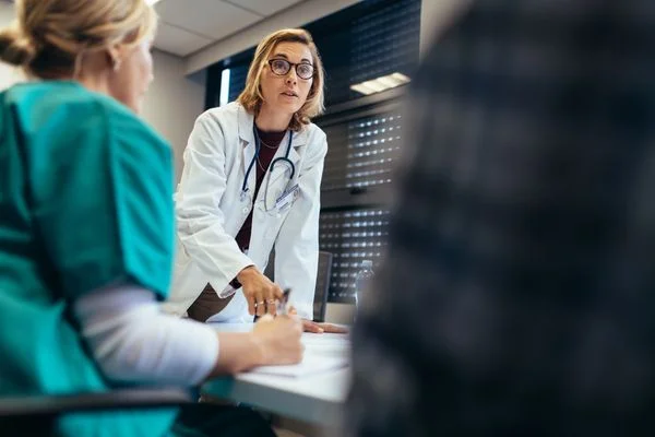 Nurse practitioner talking to her health care colleagues during a meeting